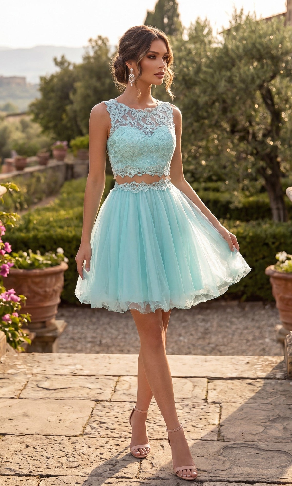 A woman wearing the Chicas C9350 short homecoming dress in aqua, featuring an illusion lace bodice and an A-line tulle skirt, is walking outdoors on a stone path in a garden.